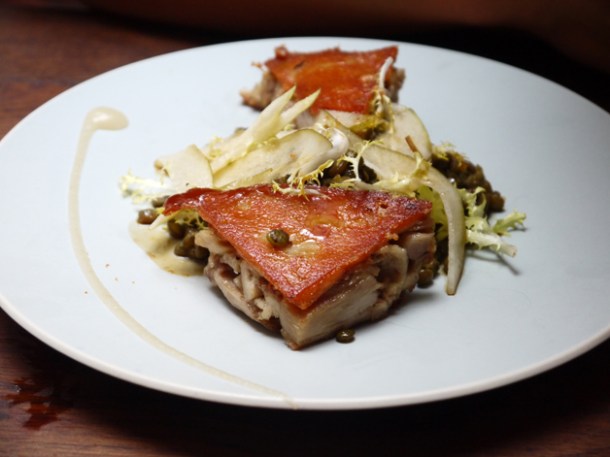 confit of suckling pig with roasted cashews, pear and lentils at Lima London confit of suckling pig with roasted cashews, pear and lentils at lima rathbone place