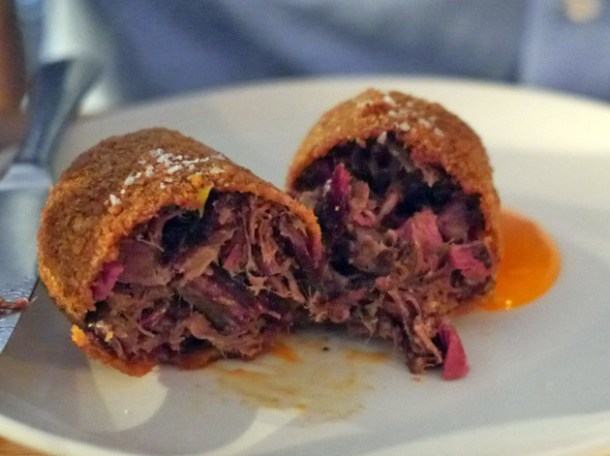 sliced open chopped brisket roll at smokehouse