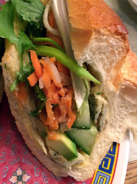 close up of avocado and omelette banh mi at miss chu
