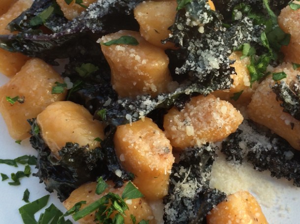 close up of pumpkin gnocchi with kale in truffle oil from pasta e basta