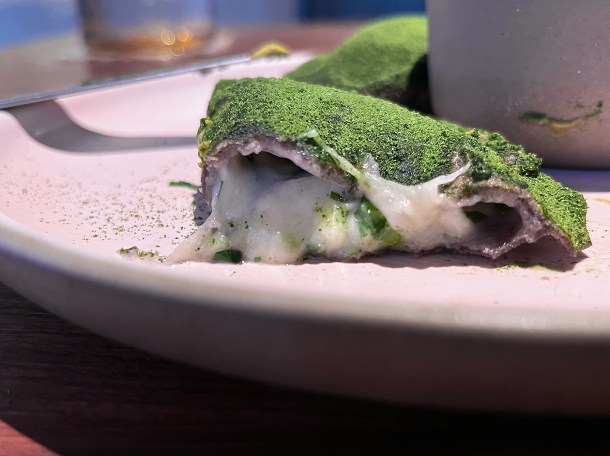 illustrative photo of the cut-open quesadilla with dehydrated wild garlic and curds at Fonda